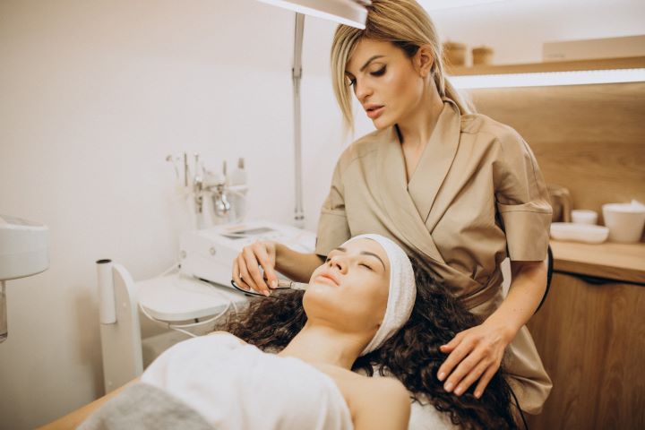 woman cosmetologist making beauty procedures