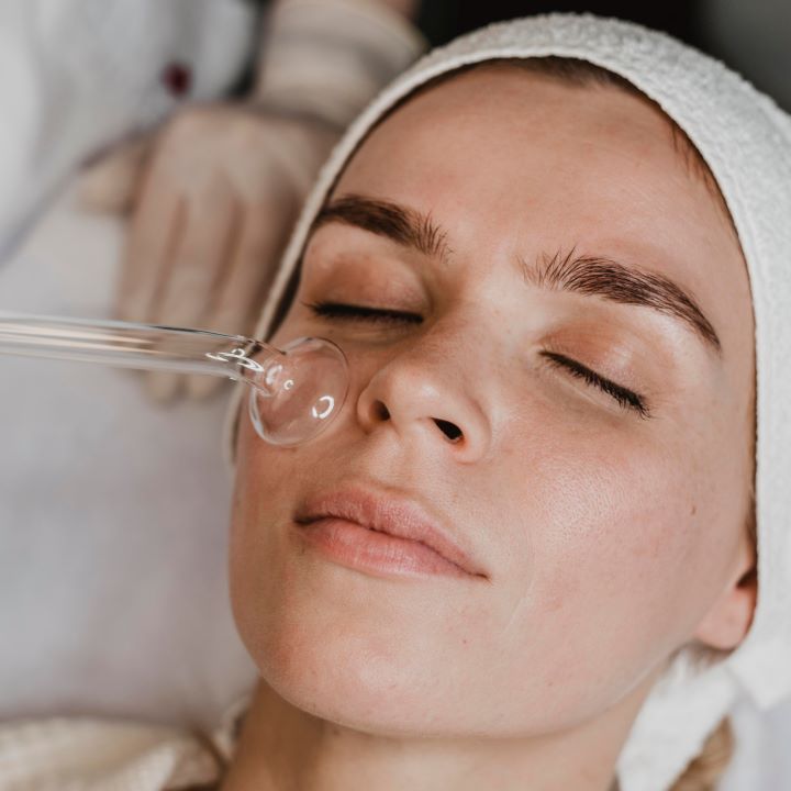 woman getting facial skin treatment wellness center
