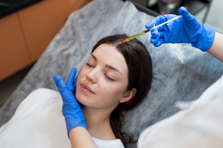 young woman getting prp injection high angle