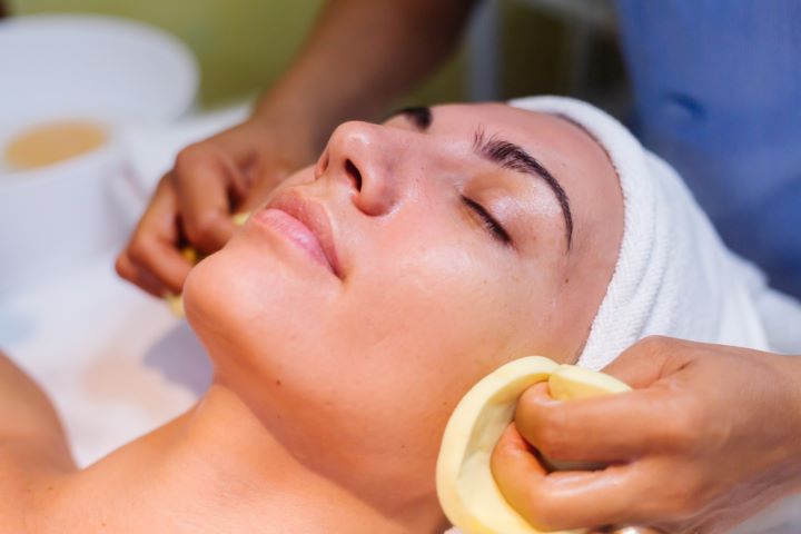 young woman lying cosmetologist s table during rejuvenation procedure